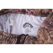 Interior branding detail view of the Sp5der Real Tree OG Web Sweatpants featuring a size large label and logo.
