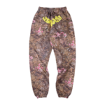 Front view of Sp5der Real Tree OG Web sweatpants in brown camouflage with yellow lettering and floral patterns.