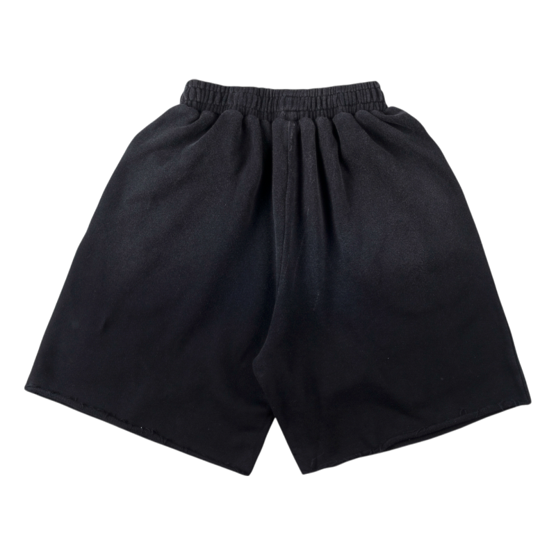 Front view of the black Sp5der cut sweatshorts featuring an elastic waistband and a comfortable, relaxed loose fit.