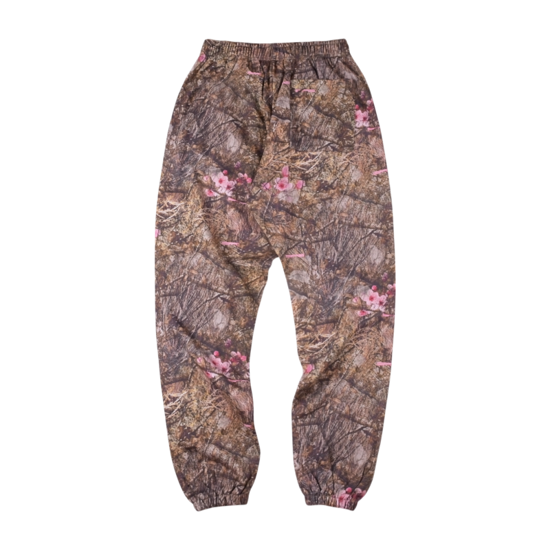 Back view of Sp5der Real Tree OG Web sweatpants featuring a brown camouflage pattern with pink floral print detailing.