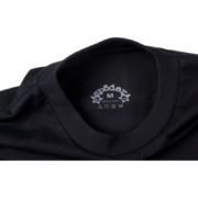 Close-up of the inner neck label on a Sp5der OG Web V2 Black Tee featuring branding and care instructions.