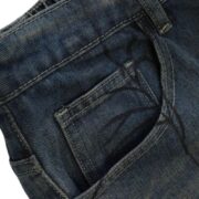 Close-up of Sp5der Print Denim Shorts featuring detailed pocket stitching and a unique dark spiderweb graphic design.