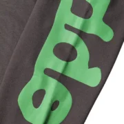 Sp5der Beluga Sweatpants in Jet Black featuring a high-quality green distressed print detail for a streetwear look.