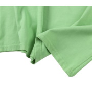 Close-up view of the premium cotton fabric texture of the Sp5der Worldwide Tee in a vibrant slime green colorway.