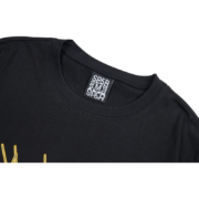 Close-up view of the SP5DER Web Print Gothic Punk T-Shirt neck label showing brand authenticity and size details.