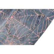 Detail view of Sp5der AOP Vintage 501 denim jeans showcasing the bold pink spider web print on classic blue denim fabric.