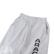 Grey Sp5der Arach NY Phobia sweatpants featuring a distressed spider web graphic print and side pocket detailing.