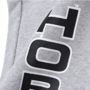 Detailed close-up view of the Sp5der Arach NY Phobia sweatpants featuring the signature graphic print on heather grey fabric