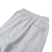A close-up view of the premium grey fabric and pocket detail of the Sp5der Arach NY Phobia sweatpants for streetwear fans.