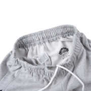 Close up view of the grey waistband and branding label on the Sp5der Arach NY Phobia sweatpants for men and women
