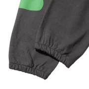 Close-up view of the cuffed hem detail on the Jet-Black Sp5der Beluga unisex sweatpants with premium fabric design.