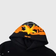 Close-up view of the black Sp5der Heavy Web Hoodie with its signature web graphic and star print design details.
