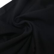 Close-up view of the premium cotton fabric texture used for the SP5DER Black OG Web Sweatpants, showcasing quality.