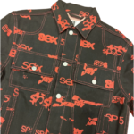 Front view of the Sp5der 5ex AOP denim trucker jacket featuring an all-over red print on a classic black denim base.