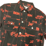 Front view of the Sp5der 5ex AOP denim trucker jacket featuring an all-over red print on a classic black denim base.