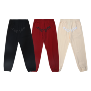 Three pairs of Sp5der OG Tree Camo sweatpants featuring urban tactical designs in black, red, and cream colorways.