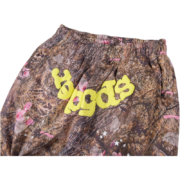 Sp5der Real Tree OG Web Sweatpants featuring iconic camouflage print, signature web design, and bold yellow lettering.