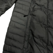 A detailed close-up view of the black Sp5der men’s light down puffer jacket, highlighting its quilted texture and pocket.