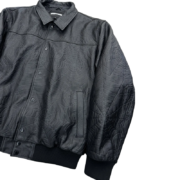 Front view of the SP5DER debossed web studded leather jacket, featuring a black premium design for streetwear style.