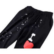 Black Sp5der Souvenir SP5 Sweatpants featuring a unique heart and star graphic pattern in a comfortable loose fit.