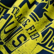 Close-up of the Sp5der Navy Campus Tee featuring a bold, weathered yellow graphic print on premium navy blue cotton.