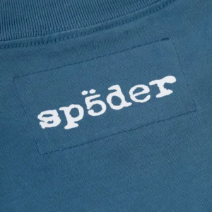 Close-up view of the white signature SP5DER logo printed on the back neck area of the blue Sp5der Actavist tee shirt.