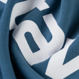 Detailed close-up view of the premium graphic print on the blue Sp5der Actavist Tee streetwear t-shirt.