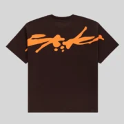 Back view of the brown Sp5der TM Tee featuring a bold orange graphic print across the upper back of the cotton shirt.