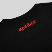 Close up view of the signature red SP5DER brand logo printed on the back neck of the black Sp5der Toast Tee shirt.