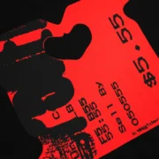 Close-up view of the bold red and black bread tag graphic print on the SP5DER Black Toast T-shirt for streetwear fans.