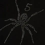 Close up view of the Sp5der Black Rhinestone TM Tee featuring a sparkling rhinestone-embellished spider web logo.