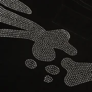 Close-up view of the black Sp5der TM Rhinestone Tee featuring intricate, high-shine rhinestone graphic detailing.