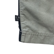Close-up detail of the fabric texture and brand tag on a pair of grey Elastic Waist Sp5der Print Shorts for men