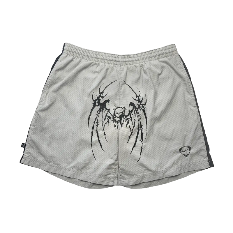 Light gray Sp5der streetwear shorts featuring a distinctive black graphic print and a comfortable elastic waistband.