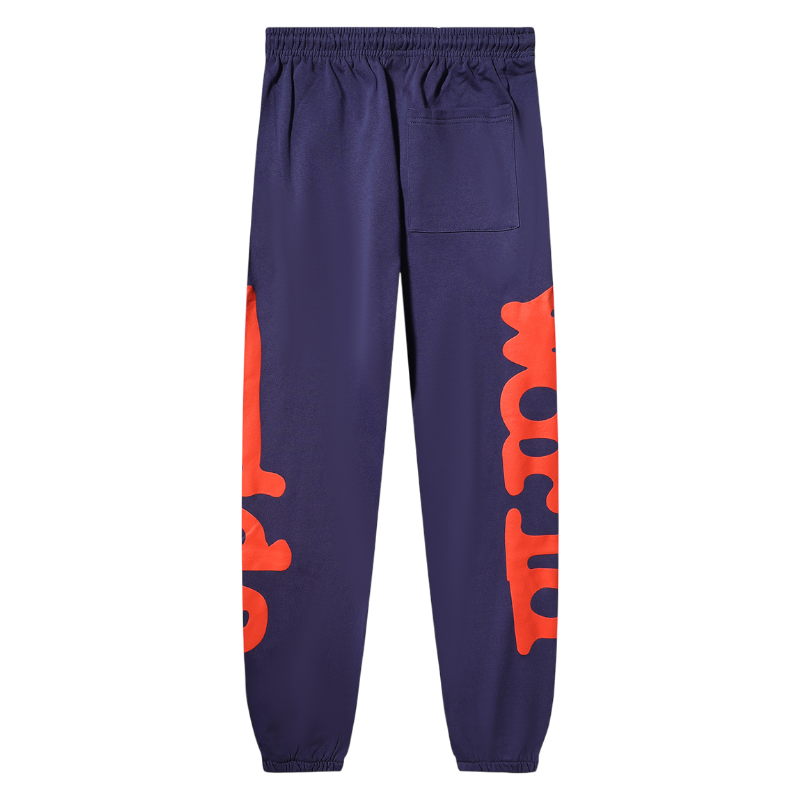 Back view of the Navy-Blue Sp5der Beluga unisex sweatpants with orange graphic print details on the legs.