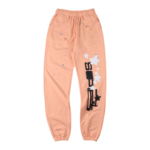Front view of the Sp5der Bellini sweatpants in a vibrant peach hue featuring a unique graphic logo and star detailing.