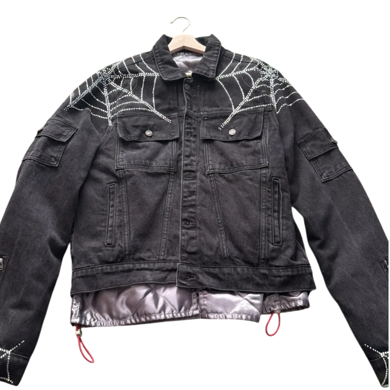Sp5der Worldwide black denim jacket featuring signature rhinestone spider web detailing and a premium streetwear aesthetic.