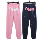Pair of Sp5der Atlanta sweatpants in pink and blue, featuring the iconic brand logo and star-patterned streetwear design.