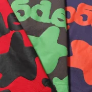 Close-up view of the high-quality fabric and unique graphic print details on the Sp5der Beluga hoodie collection.