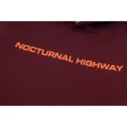 Close-up view of the Sp5der Nocturnal Highway Hoodie in maroon featuring orange front text branding and cotton fabric.