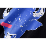 Detailed close-up view of the bold blue spider-inspired graphic print on the premium Sp5der L'Araignee T-Shirt design.