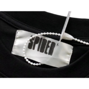Close-up view of the branded neck label and size tag on a black Sp5der Jeffery heavyweight t-shirt for authentication.