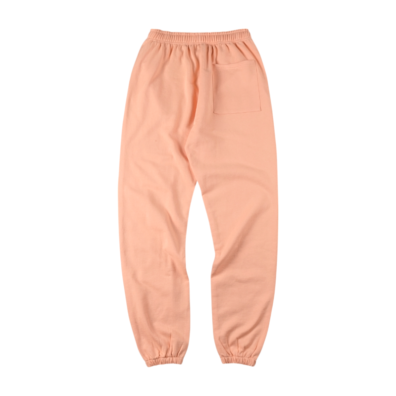 Back view of the vibrant peach Sp5der Bellini sweatpants featuring an elasticated waistband and a comfortable loose fit.