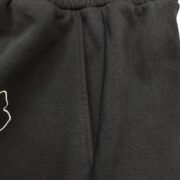 Close-up view of the black Sp5der sweatshorts showing the premium cotton fabric and the signature OG logo embroidery.