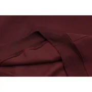 Close-up view of the premium maroon fabric texture of the Sp5der Nocturnal Highway Hoodie showcasing quality material.