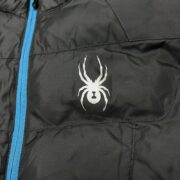 Sp5der men’s light down puffer jacket featuring the iconic white spider logo branding on a black quilted fabric shell.