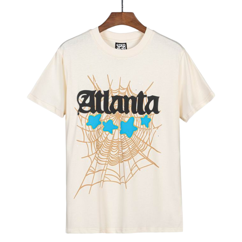 Sp5der Atlanta graphic t-shirt in cream featuring a signature web print and blue stars, front view for streetwear fans.