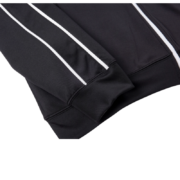 Close-up of the black Sp5der G550 jacket sleeve, highlighting its premium fabric and stylish white piping detail.