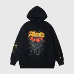 Black Sp5der Atlanta Star-Print Hoodie featuring a graphic web design and yellow stars in an oversized streetwear fit