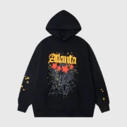 Black Sp5der Atlanta Star-Print Hoodie featuring a graphic web design and yellow stars in an oversized streetwear fit